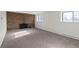 Living room with brick fireplace and large windows at 3124 W 9Th Avenue Pl, Broomfield, CO 80020