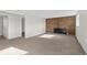 Living room featuring a brick fireplace and carpet at 3124 W 9Th Avenue Pl, Broomfield, CO 80020