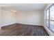 Simple living room with wood-look floors and large window at 3124 W 9Th Avenue Pl, Broomfield, CO 80020