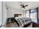 Cozy bedroom with a full-size bed, ceiling fan, and a home office space at 17725 E 99Th Ave, Commerce City, CO 80022