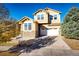 Two-story house with stone and siding exterior, attached garage, and landscaping at 17725 E 99Th Ave, Commerce City, CO 80022