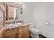 Small bathroom with granite vanity and white toilet at 721 Aspen Way, Evergreen, CO 80439