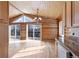 Open kitchen and dining area with wood floors and log cabin details at 721 Aspen Way, Evergreen, CO 80439