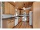 Bright kitchen with wood cabinets, granite counters, and white appliances at 721 Aspen Way, Evergreen, CO 80439