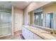 Bright bathroom with double vanity, granite counters, and glass-enclosed shower at 23981 E 40Th Ave, Aurora, CO 80019