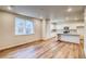 Bright, open living space with hardwood floors and a view of the kitchen at 23981 E 40Th Ave, Aurora, CO 80019