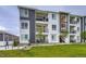 Modern apartment building with a striking two-tone color scheme and private balconies at 6153 N Ceylon St # 2-202, Denver, CO 80249