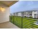 Balcony view of apartment complex over green lawns, showing multiple floors of units at 6153 N Ceylon St # 2-202, Denver, CO 80249