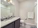 Bathroom with a granite vanity, modern fixtures, and a shower/tub combo at 6153 N Ceylon St # 2-202, Denver, CO 80249