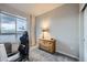 Cozy bedroom with a large window providing natural light and a comfortable chair at 6153 N Ceylon St # 2-202, Denver, CO 80249