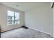 Clean bedroom with carpeted floors and a large window at 6153 N Ceylon St # 2-202, Denver, CO 80249