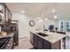 Well-appointed kitchen featuring a granite island, stainless steel appliances, and modern pendant lighting at 6153 N Ceylon St # 2-202, Denver, CO 80249
