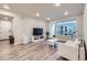 Bright living room with hardwood floors, a comfortable couch, and large windows at 6153 N Ceylon St # 2-202, Denver, CO 80249
