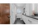 Clean bathroom with modern vanity and black and white tile floor at 4600 W Princeton Ave, Denver, CO 80236