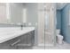 Modern bathroom with dual vanity, walk-in shower, and white tile at 4600 W Princeton Ave, Denver, CO 80236