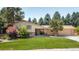 Ranch style home with brick facade, attached garage, and well-manicured lawn at 4600 W Princeton Ave, Denver, CO 80236