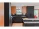 Modern kitchen with dark cabinetry, granite countertop and island at 4600 W Princeton Ave, Denver, CO 80236