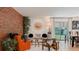 Cozy living room with brick accent wall and ample natural light at 4600 W Princeton Ave, Denver, CO 80236