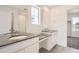 Bathroom featuring double vanity with granite countertops, ample lighting, and a glass-enclosed shower at 11008 Snowdon St, Parker, CO 80134