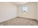 Cozy bedroom with neutral walls, plush carpet, and a bright window providing natural light at 11008 Snowdon St, Parker, CO 80134