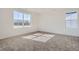 Spacious bedroom with plush carpet, ample natural light from two windows, and neutral walls at 11008 Snowdon St, Parker, CO 80134