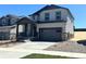 Charming two-story home features a covered porch, two-car garage, and low maintenance landscaping at 11008 Snowdon St, Parker, CO 80134