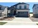 Charming two-story home features a covered porch, two-car garage, and low maintenance landscaping at 11008 Snowdon St, Parker, CO 80134