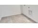 Bright laundry room featuring stylish tile flooring, white walls, and convenient hookups for washer and dryer at 11008 Snowdon St, Parker, CO 80134