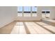 Bright living room with light hardwood floors, large windows, and sliding glass door to the backyard at 11008 Snowdon St, Parker, CO 80134