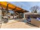 An outdoor back patio featuring a seating area, grill, and seamless indoor-outdoor living through expansive glass doors at 330 W Fair Ave, Littleton, CO 80120