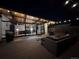 An outdoor back patio featuring a seating area, grill, and seamless indoor-outdoor living through expansive glass doors at 330 W Fair Ave, Littleton, CO 80120