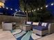 Inviting back patio features comfortable wicker seating, patterned cushions, and string lights for an ambient outdoor experience at 330 W Fair Ave, Littleton, CO 80120