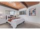 Cozy bedroom with wood ceiling, plush carpet, and large windows offering plenty of natural light at 330 W Fair Ave, Littleton, CO 80120