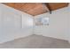 A bright and airy bedroom featuring a wood-paneled ceiling, neutral carpet, and a window with natural light and closet at 330 W Fair Ave, Littleton, CO 80120