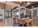 Open dining area with modern light fixture, wood ceiling and large sliding doors to the outside at 330 W Fair Ave, Littleton, CO 80120