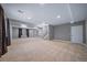 Large, carpeted basement offering ample space for recreation and entertainment at 7720 S Queensburg Way, Aurora, CO 80016