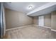 Versatile basement space featuring plush carpeting and a conveniently placed white door at 7720 S Queensburg Way, Aurora, CO 80016
