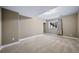 Large basement space with soft carpeting, a window, and ample natural light at 7720 S Queensburg Way, Aurora, CO 80016