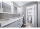 Bathroom featuring a double sink vanity and a separate toilet area at 7720 S Queensburg Way, Aurora, CO 80016