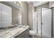Bathroom features a single granite sink vanity, a glass shower, and tile floors at 7720 S Queensburg Way, Aurora, CO 80016