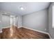 Bright bedroom featuring hardwood floors, a single window and neutral paint; a blank canvas at 7720 S Queensburg Way, Aurora, CO 80016
