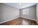 Cozy bedroom with hardwood floors and neutral paint; a serene retreat at 7720 S Queensburg Way, Aurora, CO 80016