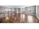 The open-concept bonus room has beautiful hardwood floors and natural light, perfect for recreation at 7720 S Queensburg Way, Aurora, CO 80016