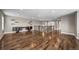 This bonus room features sleek hardwood floors, built-in desk and shelving and great natural light at 7720 S Queensburg Way, Aurora, CO 80016