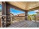 Covered deck featuring stone pillar bases with wood flooring and a scenic view at 7720 S Queensburg Way, Aurora, CO 80016