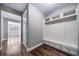 Inviting entryway with hardwood floors, a coat rack, and convenient storage bench at 7720 S Queensburg Way, Aurora, CO 80016