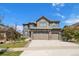 Charming two-story home featuring a three car garage, stone accents, and landscaped yard at 7720 S Queensburg Way, Aurora, CO 80016