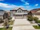 Beautiful two-story home featuring an attached three car garage and landscaped yard at 7720 S Queensburg Way, Aurora, CO 80016