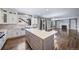 Spacious kitchen island overlooks stainless steel sink, hardwood floors, and fireplace at 7720 S Queensburg Way, Aurora, CO 80016