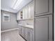 Spacious laundry room with ample cabinet space and modern appliances at 7720 S Queensburg Way, Aurora, CO 80016